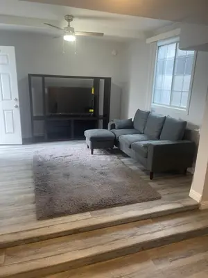 a living room with a couch and a flat screen tv at West LA Chariton in Los Angeles
