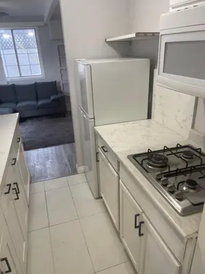 a kitchen with a stove and a white counter top at West LA Chariton in Los Angeles