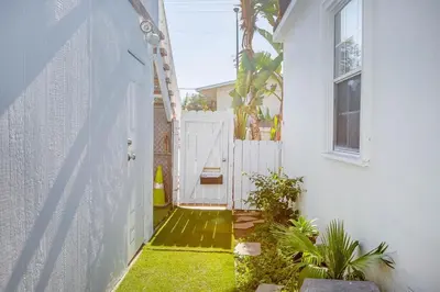 an entrance to a house with a white gate at West LA Chariton in Los Angeles