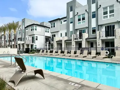 a hotel swimming pool with chairs and condos at #Marbella Lane-Luxury Designer 3BR Home Disneyland in Anaheim