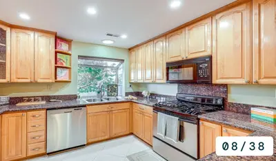 a kitchen with wooden cabinets and stainless steel appliances at Emeric Estate in Simi Valley