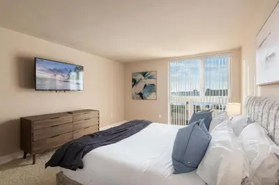 a bedroom with a large white bed and a window at The Citrine Suite - Water View Large Condo 2BR Marina in Los Angeles