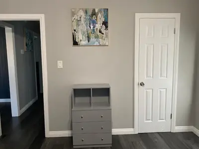 a room with a dresser and a painting on the wall at Faith House in Los Angeles