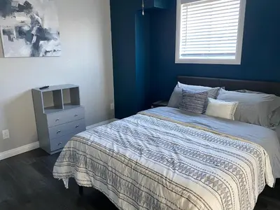a bedroom with a bed and a blue wall at Faith House in Los Angeles