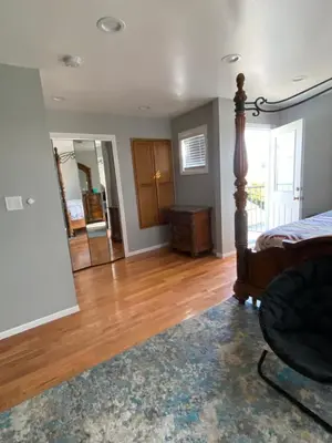 a living room with a bed and a mirror at Faith House in Los Angeles