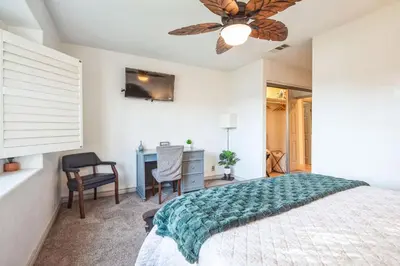 a bedroom with a bed and a desk at Peaceful Oasis in Anaheim