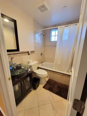 a bathroom with a toilet and a sink and a shower at 3 bedroom apartment by the MrC Hotel and 5 minutes to Rodeo Drive WiFi TV Patio walk to restaurants in Los Angeles