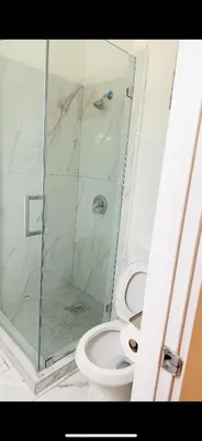 a bathroom with a toilet and a glass shower at Pretty bedroom private bathroom in Hacienda Heights