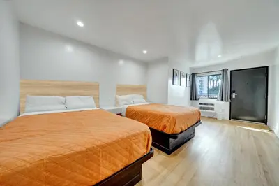a bedroom with two beds and a large window at Casablanca Inn in Bell
