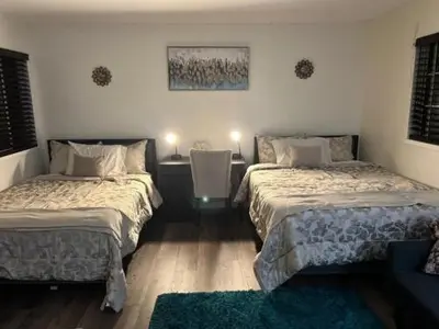 a bedroom with two beds and a table with two lamps at Travelers Mini Stays - Revelation Nation Welcome in Simi Valley