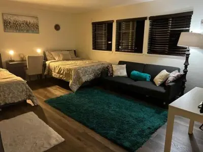 a living room with two beds and a couch at Travelers Mini Stays - Revelation Nation Welcome in Simi Valley