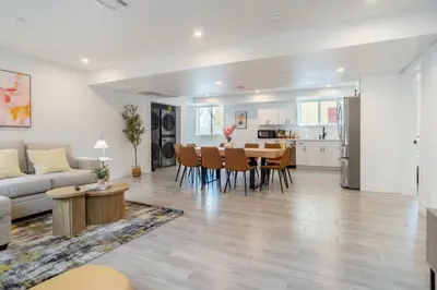 a living room and kitchen with a table and chairs at Cozy Urban Retreat near Downtown LA & USC - Private room with shared Living room and kitchen in Los Angeles
