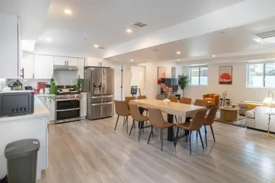 a kitchen and dining room with a table and chairs at Cozy Urban Retreat near Downtown LA & USC - Private room with shared Living room and kitchen in Los Angeles