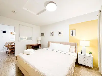 a white bedroom with a bed and a desk at Cozy 1-BR Poolside Getaway in West LA - LOU2 - WW in Los Angeles