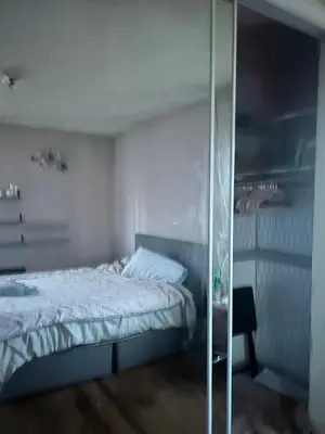 a bedroom with a bed and a glass wall at Cheryls home in Inglewood