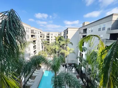 an overhead view of a hotel with a pool and palm trees at 2BD 2BA Santa Monica Apartment with Relaxing Pool View in Los Angeles