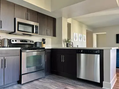 a kitchen with stainless steel appliances and a microwave at 2BD 2BA Santa Monica Apartment with Relaxing Pool View in Los Angeles