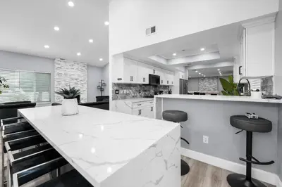 a white kitchen with a large white counter top at Spacious 4-bedroom Glendora Super House in Glendora