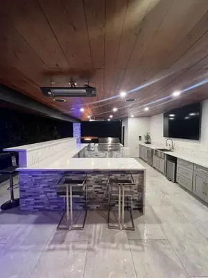 a large kitchen with a large counter with stools at Spacious 4-bedroom Glendora Super House in Glendora