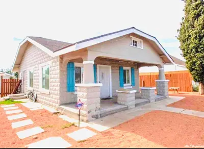 a small house with a blue door at Cozy Home Away From Home in Mojave