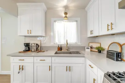 a white kitchen with white cabinets and a sink at Centrally Located Charming LA Home with Food Scenes in Monterey Park
