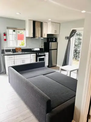 a living room with a couch in a kitchen at Cozy Serene Studio Backhouse w parking near it all in South Gate
