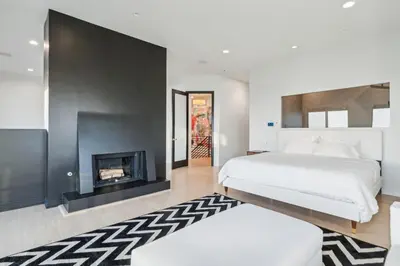 a bedroom with a bed and a fireplace at Hollywood Hills Luxury Nest in Los Angeles