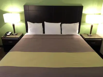 a bedroom with a large bed with two lamps at Inn Of Long Beach in Long Beach