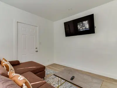 a living room with a couch and a tv on a wall at Modern 3 Bedroom Apartment in San Fernando in San Fernando