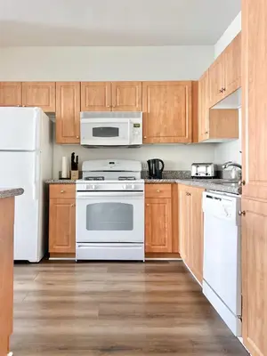 a kitchen with white appliances and wooden cabinets at 2BD 2BTH Apartment in Marina Del Rey - Free Parking - 20 mins to LAX in Los Angeles