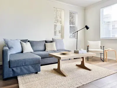 a living room with a blue couch and a coffee table at 2BD 2BTH Apartment in Marina Del Rey - Free Parking - 20 mins to LAX in Los Angeles