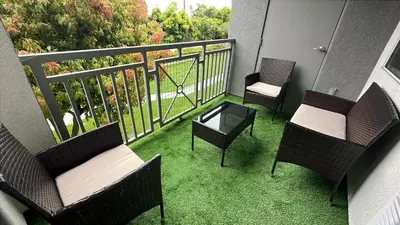 three chairs and a table on a balcony with grass at 2BD 2BTH Apartment in Marina Del Rey - Free Parking - 20 mins to LAX in Los Angeles