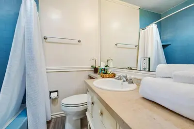 a bathroom with a sink and a toilet and a mirror at Beach Breeze Bungalow 1 Miles To Beach Cozy in Redondo Beach
