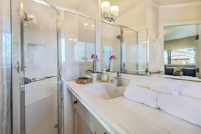 a bathroom with a sink and a shower and a mirror at Beach Breeze Bungalow 1 Miles To Beach Cozy in Redondo Beach