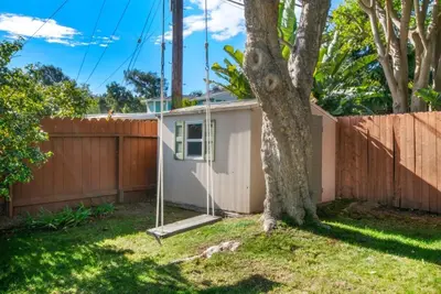a house with a fence and a tree at Beach Breeze Bungalow 1 Miles To Beach Cozy in Redondo Beach