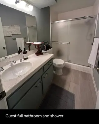 a bathroom with a sink and a toilet and a shower at Best Location West LA Spacious condo with hottub in Los Angeles