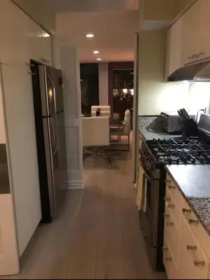 a kitchen with a refrigerator and a stove top oven at Best Location West LA Spacious condo with hottub in Los Angeles