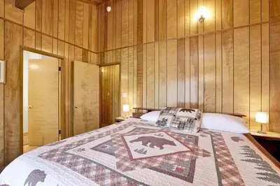 a bedroom with a bed with a quilt on it at Inspiration Point Retreat by Big Bear Vacations in Big Bear Lake