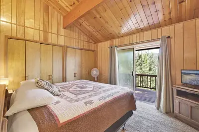 a bedroom with a bed and a large window at Inspiration Point Retreat by Big Bear Vacations in Big Bear Lake