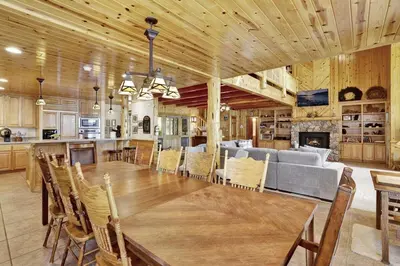a dining room and kitchen with a table and a couch at Eagle Point Lake House by Big Bear Vacations in Big Bear Lake