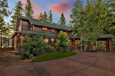 a large wooden house with a gambrel roof at Eagle Point Lake House by Big Bear Vacations in Big Bear Lake