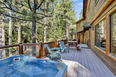 a jacuzzi tub on the deck of a cabin at Eagle Point Lake House by Big Bear Vacations in Big Bear Lake