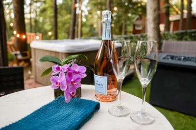 a bottle of wine and two wine glasses on a table at The Nest on Towne Trail by Big Bear Vacations in Big Bear Lake