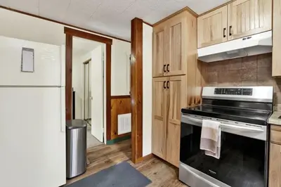 a kitchen with a stove and a refrigerator at Green Squirrel Chateau by Big Bear Vacations in Big Bear Lake