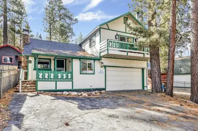 a green and white house with a garage at Green Squirrel Chateau by Big Bear Vacations in Big Bear Lake