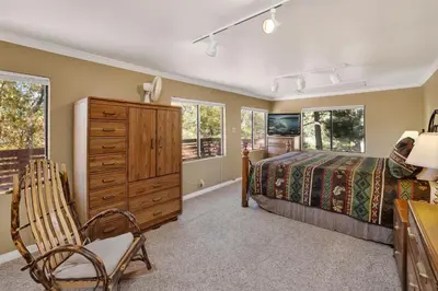 a bedroom with a bed and a dresser at Mountain Hideaway on Maryland by Big Bear Vacations in Big Bear Lake