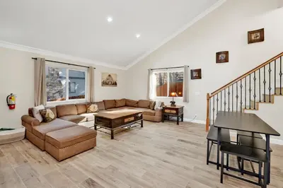 a living room with a couch and a table at Temple Bear Chalet by Big Bear Vacations in Big Bear Lake
