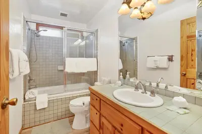 a bathroom with a sink and a tub and a toilet at Oriole House- Walk to Lake Chalet w/ Hot Tub in Big Bear Lake