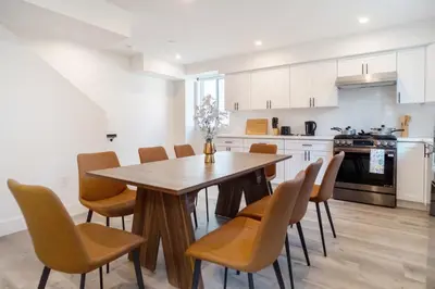 a kitchen with a wooden table and chairs at Chic & Comfortable Space Near Downtown LA & USC in Los Angeles