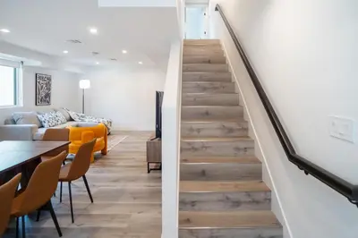 a staircase leading to the second floor of a house at Stylish & Cozy Retreat Near USC & Downtown LA in Los Angeles